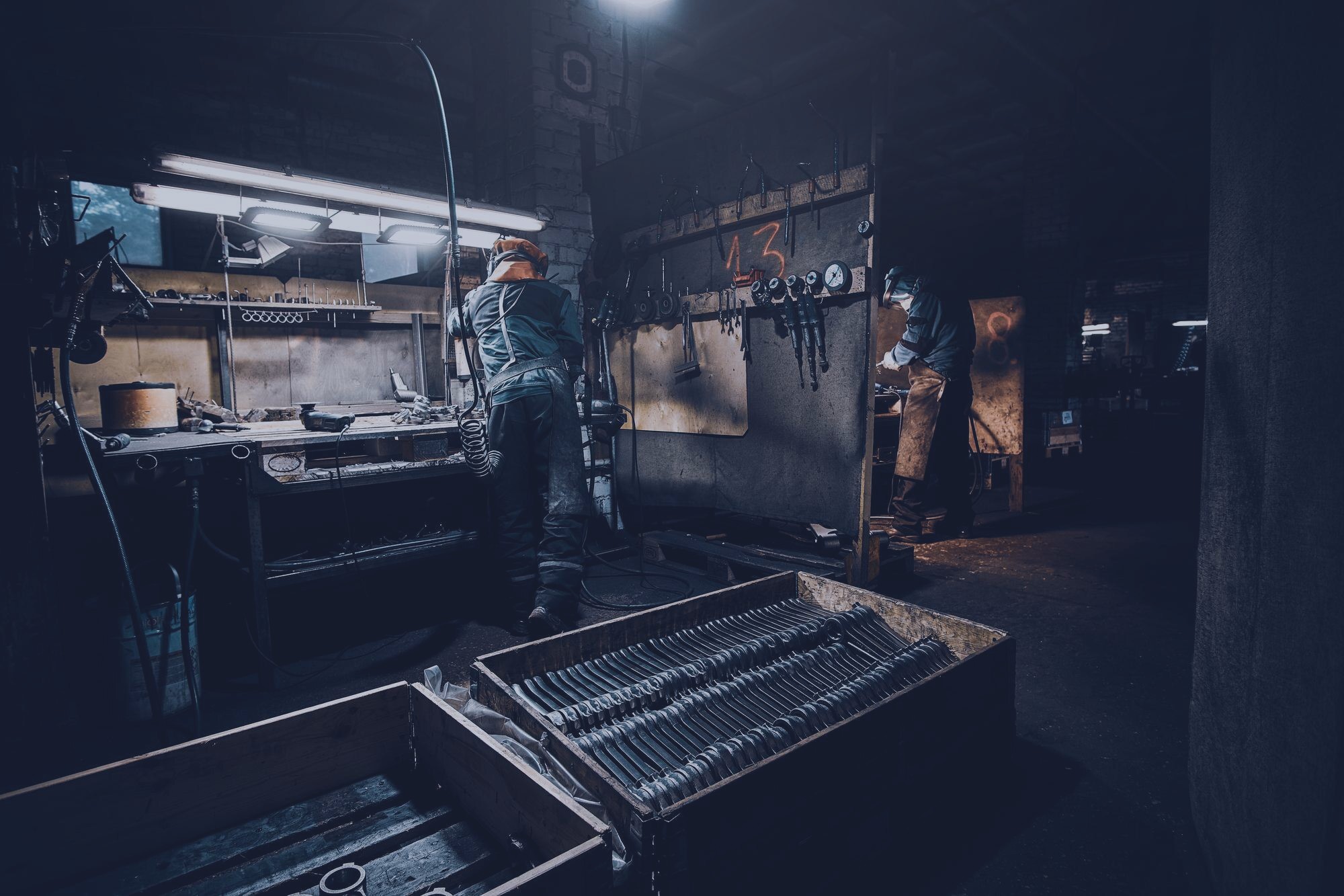 Manufacturing engineers in a dark industrial facility